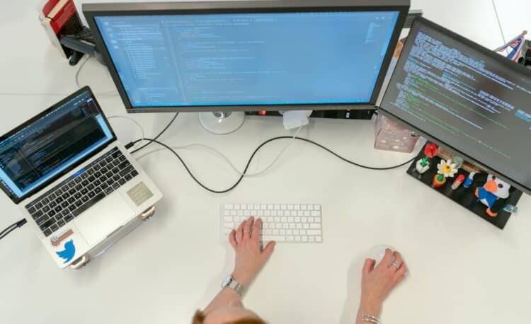 female software engineer coding on computer